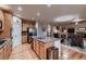 Kitchen featuring wood cabinets, stainless steel appliances, and an open layout with a view to the living room at 1805 Parkdale N Cir, Erie, CO 80516