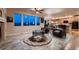 Living room boasts tile flooring, a ceiling fan, large windows, and a view to the kitchen area at 1805 Parkdale N Cir, Erie, CO 80516