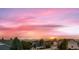 Sunset view from rooftop with colorful skies and mountain views over the neighborhood at 1805 Parkdale N Cir, Erie, CO 80516