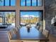 Bright dining area with stunning mountain views, an elegant table, and easy access to the outdoor patio at 132 N Gold Flake Ter, Breckenridge, CO 80424