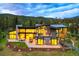 Stunning mountain home with expansive windows, outdoor living spaces, and beautifully landscaped grounds at 132 N Gold Flake Ter, Breckenridge, CO 80424