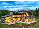 Stunning mountain home featuring expansive windows, stone accents, and outdoor living spaces against a scenic backdrop at 132 N Gold Flake Ter, Breckenridge, CO 80424
