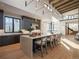 Modern kitchen features a large island with seating, stainless steel appliances, and ample natural light creating a culinary haven at 132 N Gold Flake Ter, Breckenridge, CO 80424