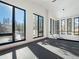 Bright living area with large windows showcasing mountain views, modern lighting, and sleek black floors at 132 N Gold Flake Ter, Breckenridge, CO 80424