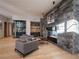 Elegant living room with stone fireplace, custom wine bar, and stylish furniture at 132 N Gold Flake Ter, Breckenridge, CO 80424