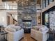 Inviting living room features a stone fireplace and comfortable seating, creating an ideal space for relaxation and conversation at 132 N Gold Flake Ter, Breckenridge, CO 80424
