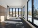 Sunlit living space features expansive windows with wintery mountain views and sleek black floors at 132 N Gold Flake Ter, Breckenridge, CO 80424