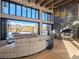 Open-concept living area with floor-to-ceiling windows, stone fireplace, and elegant dining perfect for entertaining at 132 N Gold Flake Ter, Breckenridge, CO 80424