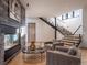 Bright living room featuring a stone fireplace, modern staircase, and comfortable seating at 132 N Gold Flake Ter, Breckenridge, CO 80424