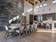 Spacious living area with a stone fireplace, large windows, and an open kitchen offering mountain views at 132 N Gold Flake Ter, Breckenridge, CO 80424