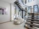 Modern staircase with glass railings allows natural light to flow through the home; mountain views visible at 132 N Gold Flake Ter, Breckenridge, CO 80424