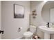Stylish powder room with modern fixtures, floating shelves, decorative art, and a pedestal sink at 3765 W 88Th Ct, Westminster, CO 80031
