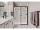 Modern bathroom featuring a double sink vanity, a glass-enclosed shower with marble-style tiling, and contemporary fixtures at 3765 W 88Th Ct, Westminster, CO 80031