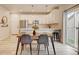 Bright dining area open to kitchen, features modern table, chairs and light fixtures at 3765 W 88Th Ct, Westminster, CO 80031