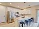 Modern kitchen with stainless steel appliances, white cabinetry, and a breakfast bar at 3765 W 88Th Ct, Westminster, CO 80031