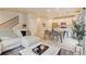 Open-concept living space with modern decor, a staircase, and a view into the kitchen at 3765 W 88Th Ct, Westminster, CO 80031