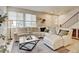 Cozy living room featuring a sectional sofa, marble coffee table, and large windows at 3765 W 88Th Ct, Westminster, CO 80031