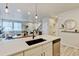 Bright, open layout with a kitchen island overlooking the living room and dining area, maximizing space and light at 3765 W 88Th Ct, Westminster, CO 80031