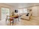 Open-concept living area featuring a dining table with a bench, a comfortable couch, and natural light at 3765 W 88Th Ct, Westminster, CO 80031