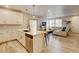 Open kitchen and living room, light colored hardwood floors, white kitchen, stainless appliances at 3765 W 88Th Ct, Westminster, CO 80031