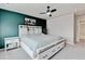 Comfortable bedroom featuring a decorative accent wall, a well-lit nightstand, and an inviting, cozy atmosphere at 3765 W 88Th Ct, Westminster, CO 80031