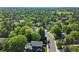 Wide neighborhood view featuring lush, mature trees, homes, and the street at 3726 E Nichols Ave, Centennial, CO 80122