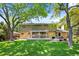 Spacious backyard features a large deck and mature trees at 3726 E Nichols Ave, Centennial, CO 80122