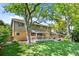 Backyard with lawn, mature trees, deck, and patio area at 3726 E Nichols Ave, Centennial, CO 80122
