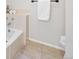 Bathroom featuring a neutral-toned tile floor and a bathtub with chrome fixtures at 3726 E Nichols Ave, Centennial, CO 80122