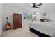 Neutral bedroom with a ceiling fan, window with blinds, and dark wood furniture at 3726 E Nichols Ave, Centennial, CO 80122