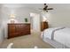 Cozy bedroom showcasing neutral walls, ceiling fan, and dark wood furnishings at 3726 E Nichols Ave, Centennial, CO 80122