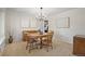 Cozy dining room with traditional furnishings, neutral carpet, and elegant chandelier at 3726 E Nichols Ave, Centennial, CO 80122
