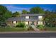 Charming two-story home featuring a well-manicured lawn, mature trees, and a welcoming facade with brick and neutral siding at 3726 E Nichols Ave, Centennial, CO 80122