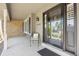 Cozy front porch with a chair, decorative pillow, and a view of the detailed front door with sidelights at 3726 E Nichols Ave, Centennial, CO 80122