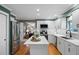 Modern kitchen featuring stainless steel appliances, a center island, white cabinetry, and hardwood flooring at 3726 E Nichols Ave, Centennial, CO 80122