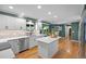 Bright kitchen with an island, stainless steel appliances, and a view into the dining area for easy meal preparation at 3726 E Nichols Ave, Centennial, CO 80122
