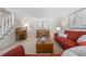 Inviting living room featuring comfortable seating, a piano, a wooden desk, and bright lighting for a welcoming atmosphere at 3726 E Nichols Ave, Centennial, CO 80122