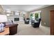 Inviting living room with a white brick fireplace, built-in shelves, and bay window at 3726 E Nichols Ave, Centennial, CO 80122