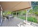 Outdoor living: Covered patio with table and chairs overlooking a lush yard at 3726 E Nichols Ave, Centennial, CO 80122