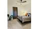 A spacious bedroom featuring a ceiling fan and natural light from the window with curtains at 2876 W 53Rd Ave # 305, Denver, CO 80221