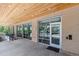 Exterior entrance with brick walls, glass doors, and wooden ceilings, offering a modern and inviting entryway at 2876 W 53Rd Ave # 305, Denver, CO 80221