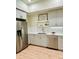 Charming kitchen features shaker style cabinets, modern backsplash, and stainless steel appliances at 2876 W 53Rd Ave # 305, Denver, CO 80221