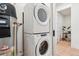 Modern laundry room features stacked washer/dryer and efficient hot water tank at 2876 W 53Rd Ave # 305, Denver, CO 80221