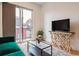 Bright living room with modern decor, balcony view, and ample natural light at 2876 W 53Rd Ave # 305, Denver, CO 80221