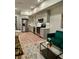 Bright living room featuring a modern kitchen and a comfortable emerald green couch at 2876 W 53Rd Ave # 305, Denver, CO 80221