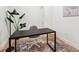 Cozy office space with a black desk, chair, area rug, and natural light at 2876 W 53Rd Ave # 305, Denver, CO 80221