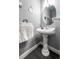 Charming half bathroom featuring a pedestal sink and stylish decor at 18242 E Bethany Pl, Aurora, CO 80013