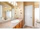 Bright bathroom featuring a vanity with a sink, mirror, decorative butterflies and a white door leading to another room at 18242 E Bethany Pl, Aurora, CO 80013