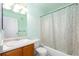 Mint green bathroom features a combination tub and shower with vanity at 18242 E Bethany Pl, Aurora, CO 80013