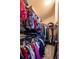 Walk-in closet with metal racks and clothing, offering storage space and organization at 18242 E Bethany Pl, Aurora, CO 80013